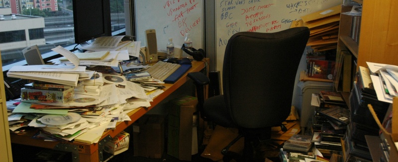 Disorganized desk with papers and books everywhere